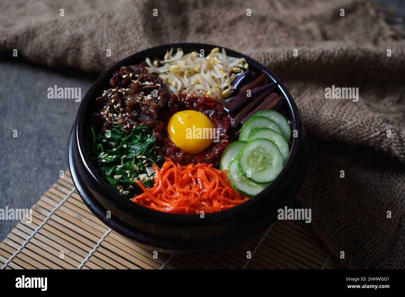 Bibimbap Reisgericht im koreanischen Stil. Schüssel mit warmem, weißem Reis mit Rindfleisch Bulgogi, Sauteed und gewürztem Gemüse gekrönt Stockfoto Bibimbap Reisgericht im koreanischen Stil. Schüssel mit warmem, weißem Reis mit Rindfleisch Bulgogi, Sauteed und gewürztem Gemüse gekrönt Stockfoto