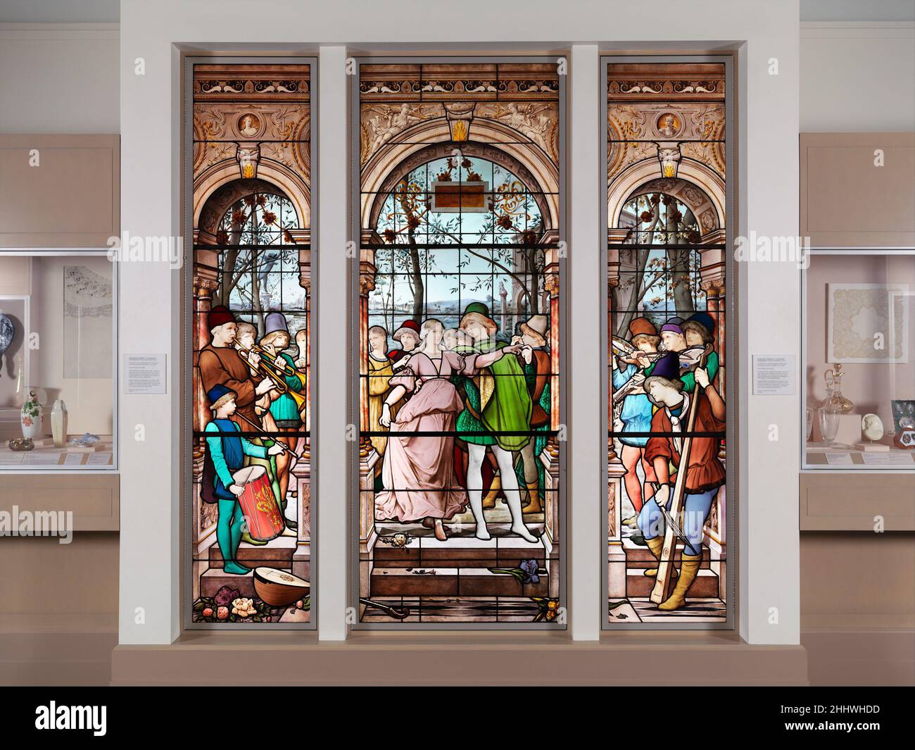 La Danse des Fiançailles 1885 Luc-Olivier Merson Französisch der Schirmherr war die Witwe von Isaac Bell, einem prominenten New Yorker in der zweiten Hälfte des 19. Jahrhunderts. Im Jahr 1906 wurden die Tafeln aus einem Erker in ihrer Wohnung im Knickerbocker-Gebäude in der Fifth Avenue in der Twenty-Eight Street entfernt. Eugène Oudinot wurde in der Porzellanfabrik Choisy-le-ROI außerhalb von Paris zum Maler ausgebildet, spezialisierte sich aber danach auf Buntglas. Er machte große Fenster für kirchliche und säkulare Installationen in seinem Haus in Passy, etwas außerhalb von Paris. La Danse des Fiançailles 188970 Stockfoto