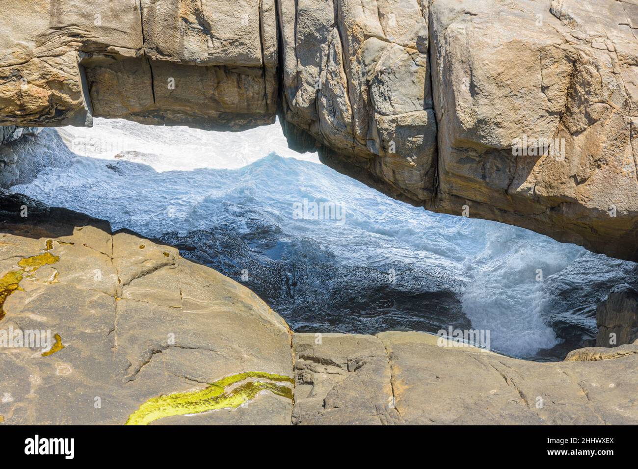 Gebänderte Gneiss-Granitfelsen bilden die beliebte Touristenattraktion der Natural Bridge im Torndirrup National Park, Albany, Westaustralien Stockfoto