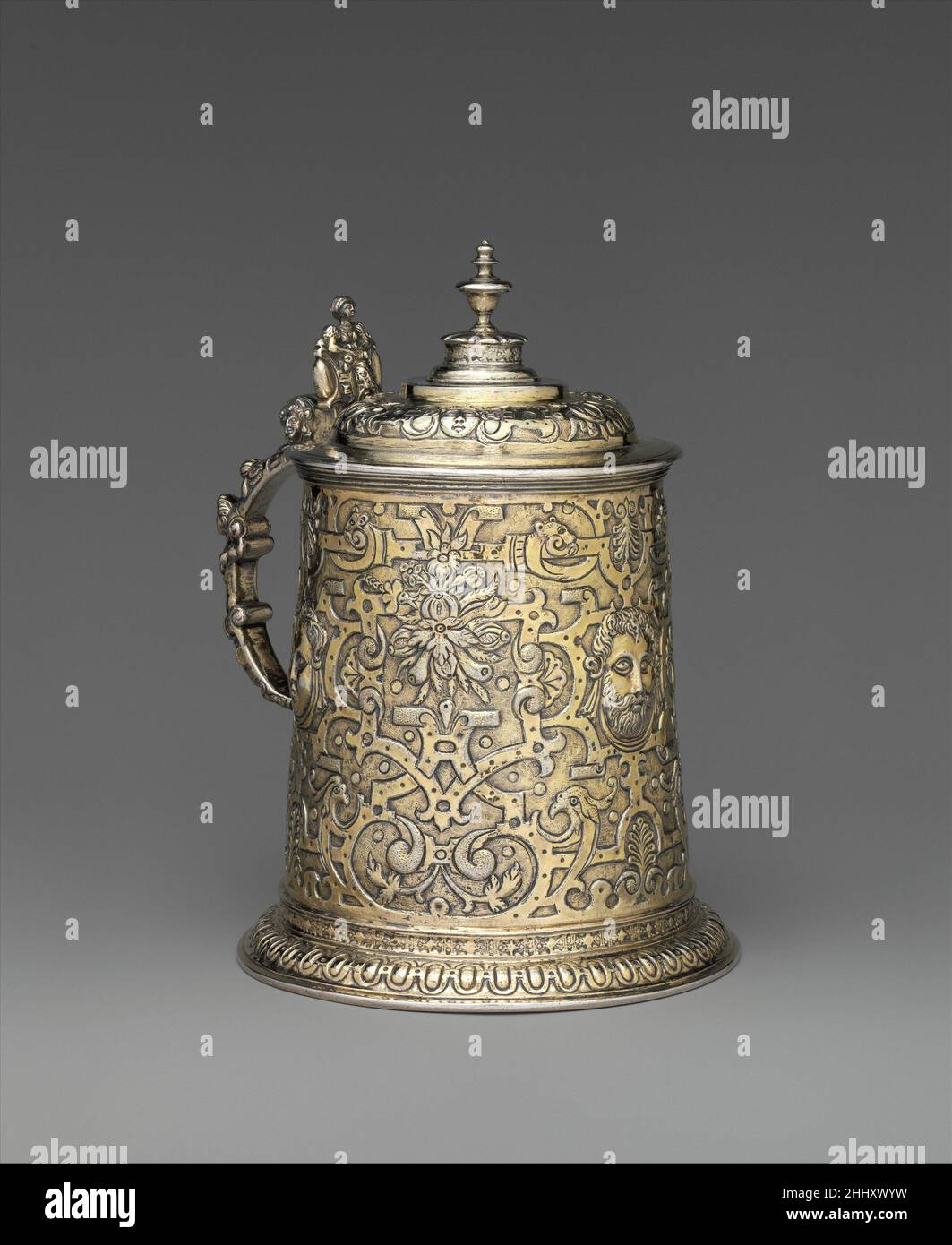 TANKARD Ende 16th. Jahrhundert Gregorius Gunesch der sich verjüngende zylindrische Körper dieses Panzers ist mit weiblichen und männlichen Masken und einem sehr dichten Muster aus Riemen- und Rollwerk sowie Festounen geprägt. Nur der gadroonierte Fußrand, der unverzierte Rahmen des Deckels und das schlichte Endstück bieten einen Moment klassischer Zurückhaltung.LiteraturEuropäisches Silber. Verkauf Kat., Sotheby’s, Genf, 13. Mai 1986, S. 32, Nr. 85.Judit H. Kolba. Ungarisches Silber: Die Sammlung Nicolas M. Salgo. London, 1996, S. 30, Nr. 8.ReferenzenTankards mit ähnlichen Griffen wurden von Dr. Fischer Kunstauktionen in Heilbronn, Best.-Nr. 181, Nr. 4, Stockfoto