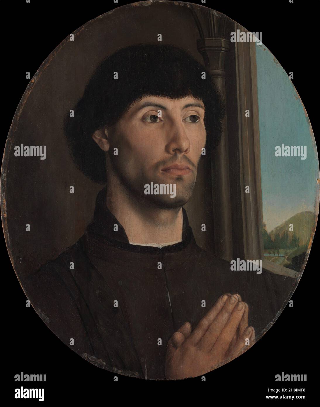 Porträt eines Mannes ca. 1475 Hugo van der Goes Niederländischer Hugo van der Goes produzierte einige der berühmtesten Altarbilder der nördlichen Renaissance. Der erhöhte Realismus dieses Porträts, insbesondere der Bartstoppel, ist ein Markenzeichen seiner Arbeit. Durch die Einstellung des Kopfes des Mannes gegen ein dunkles Interieur neben einem hellen Fenster verbessert der akzentuierte Kontrast von Licht und Schatten die Modellierung der Gesichtszüge. Das Porträt wurde später aus einer rechteckigen Tafel, die wahrscheinlich ursprünglich Teil eines hingebungsvollen Triptychons war, in eine ovale Form geschnitten. Der Sitter, mit seinen Händen verbunden in ewig Stockfoto