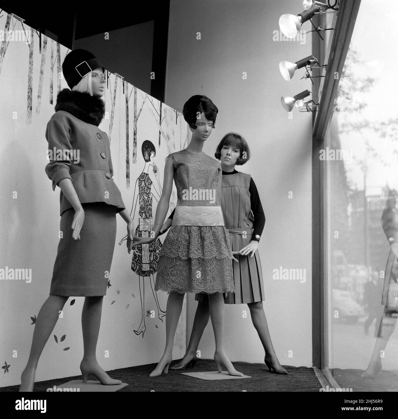 Mary Quant, Modedesignerin, steht im Fenster ihres Modehauses Bazaar, hier mit mehreren Puppen, die ihre zum Verkauf stehenden Designs tragen. Mary's Shop befindet sich in der Brompton Road, Knightsbridge, London, SW1 Aufnahme vom 14th. Oktober 1960 Stockfoto