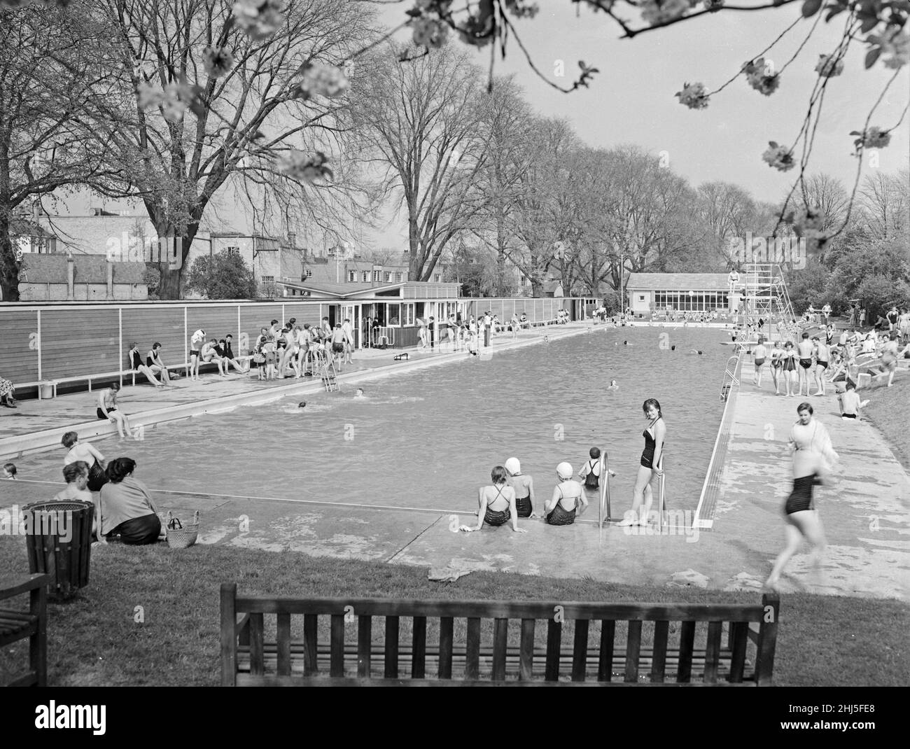 Junge Leute genießen die warme Frühlingssonne im Jesus Green, Cambridge, Cambridgeshire, Freiluft-Swimmingpool. Mai 1958 Stockfoto