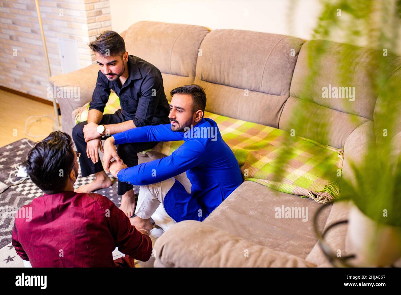 Freunde aus indien unterhalten sich im Wohnzimmer und haben Spaß Stockfoto