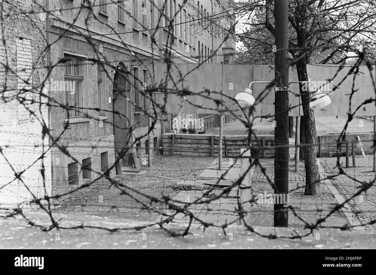 Szenen in Berlin, drei Jahre nach Beginn der Arbeiten am Bau der Berliner Mauer, die Ost und West trennt. Blick über die Mauer von West-Berlin nach Osten, der Kinder beim Spielen zeigt. 25th. Oktober 1964. Stockfoto