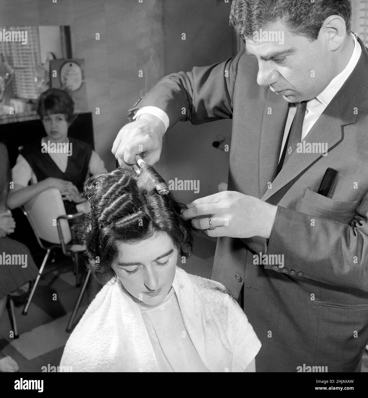 Frau hat bei den Friseuren die Haare geschnitten und gewellt, 7th. Juni 1962 Stockfoto