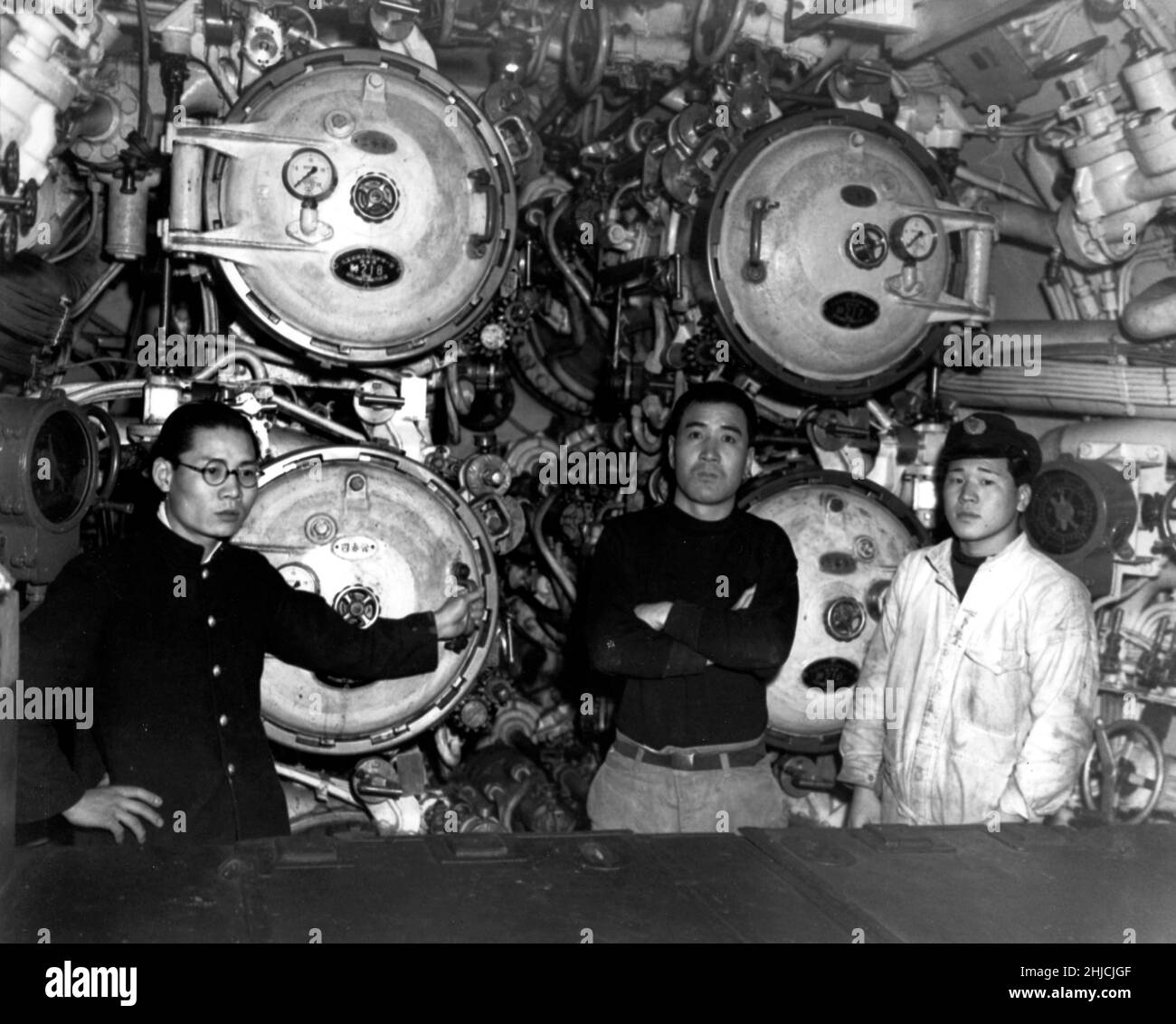 I-58 Ansicht im vorderen Torpedo-Raum, zeigt 21-Zoll-Torpedo-Rohre und drei Besatzungsmitglieder. Aufgenommen in Sasebo, Japan, 28. Januar 1946. I-58 war ein japanisches U-Boot vom Typ B3, das im letzten Jahr des Zweiten Weltkriegs diente. Ihr wichtigster Erfolg war USS Indianapolis, versenkt mit konventionellen Torpedos 30. Juli 1945. Das U-Boot ergab sich im September 1945 und wurde später von der US-Marine versenkt. (Abgeschnitten und gereinigt) Stockfoto