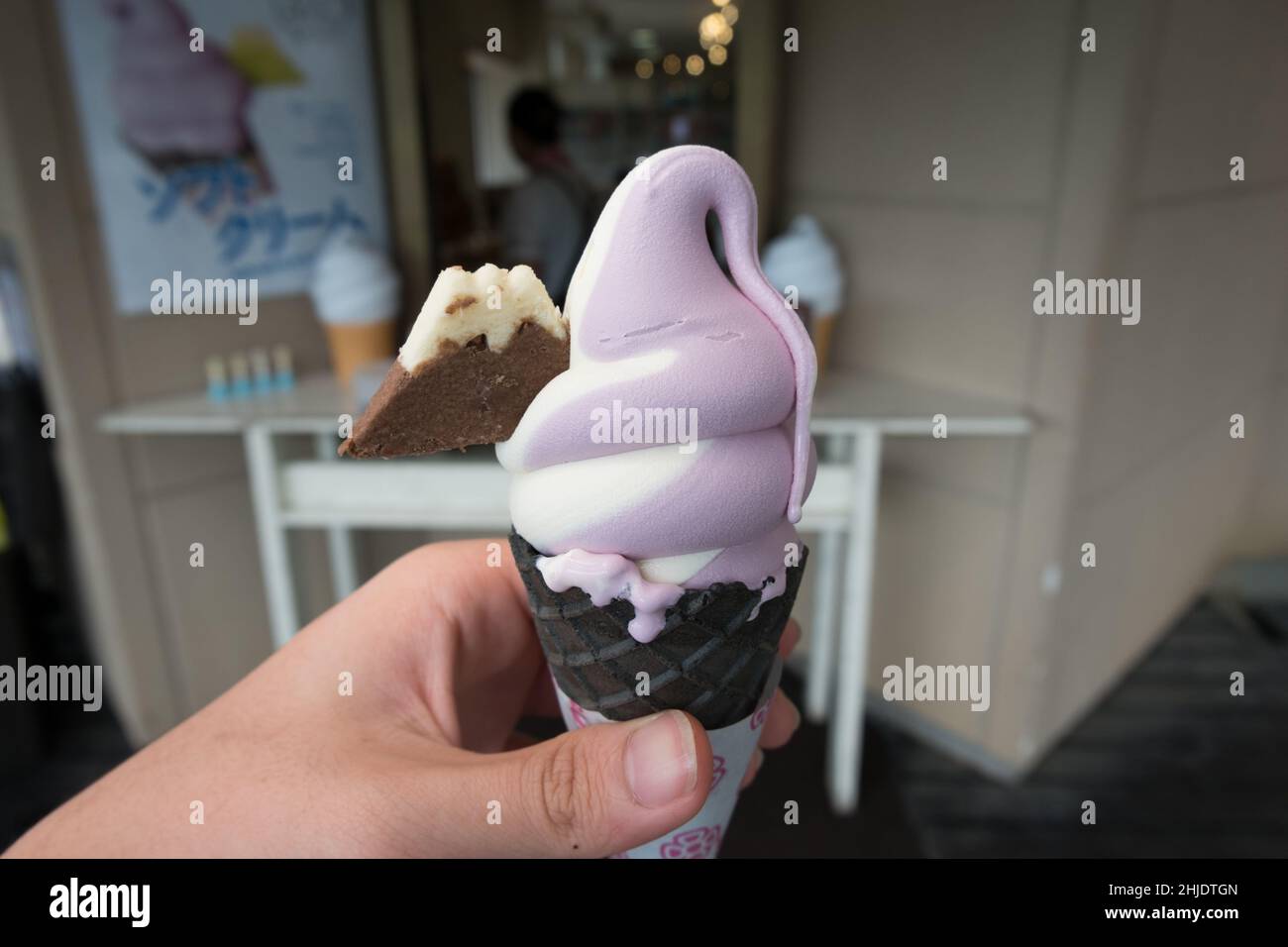 Nahaufnahme von weißem und violettem Softeis mit einem Cookie in Form eines Berges eingebettet Stockfoto