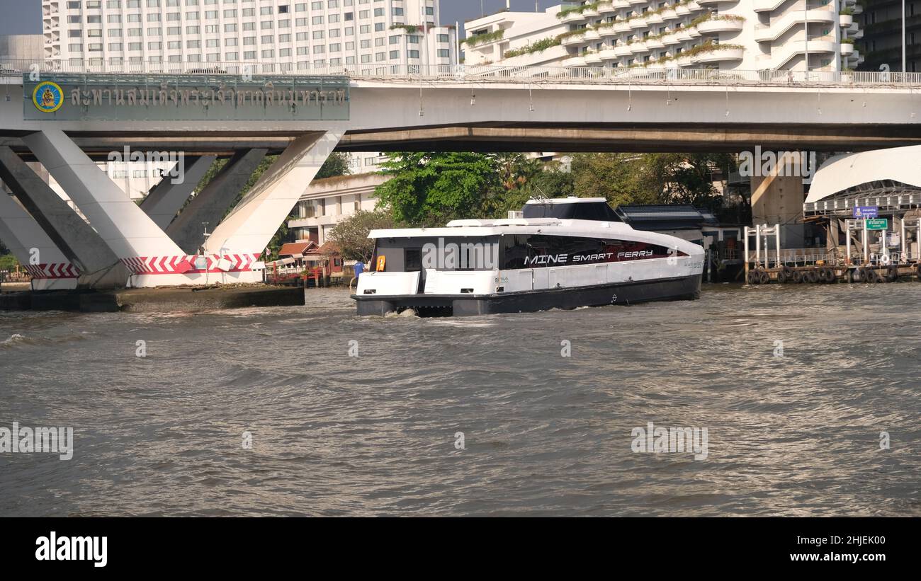 MINE Smart Ferry, Electric Catamaran Chao Phraya River, Bangkok, Thailand Taksin Bridge aka Sathon Bridge im Hintergrund Stockfoto