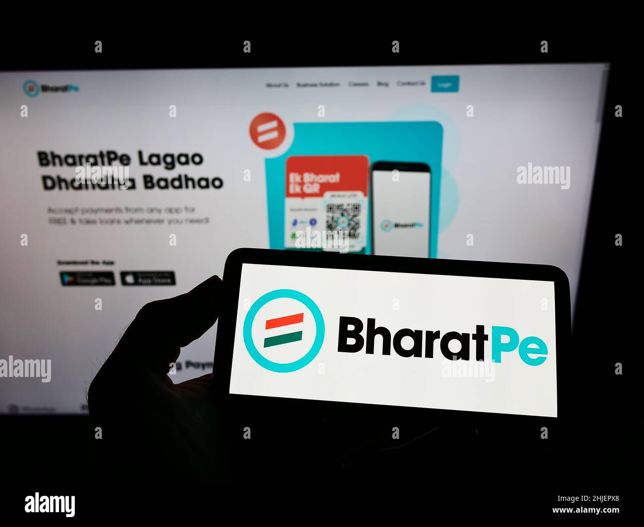 Person, die Mobiltelefon mit dem Logo des Unternehmens Resilient Innovations Pvt hält. Ltd. (BharatPe) auf dem Bildschirm vor der Webseite. Konzentrieren Sie sich auf die Telefonanzeige. Stockfoto
