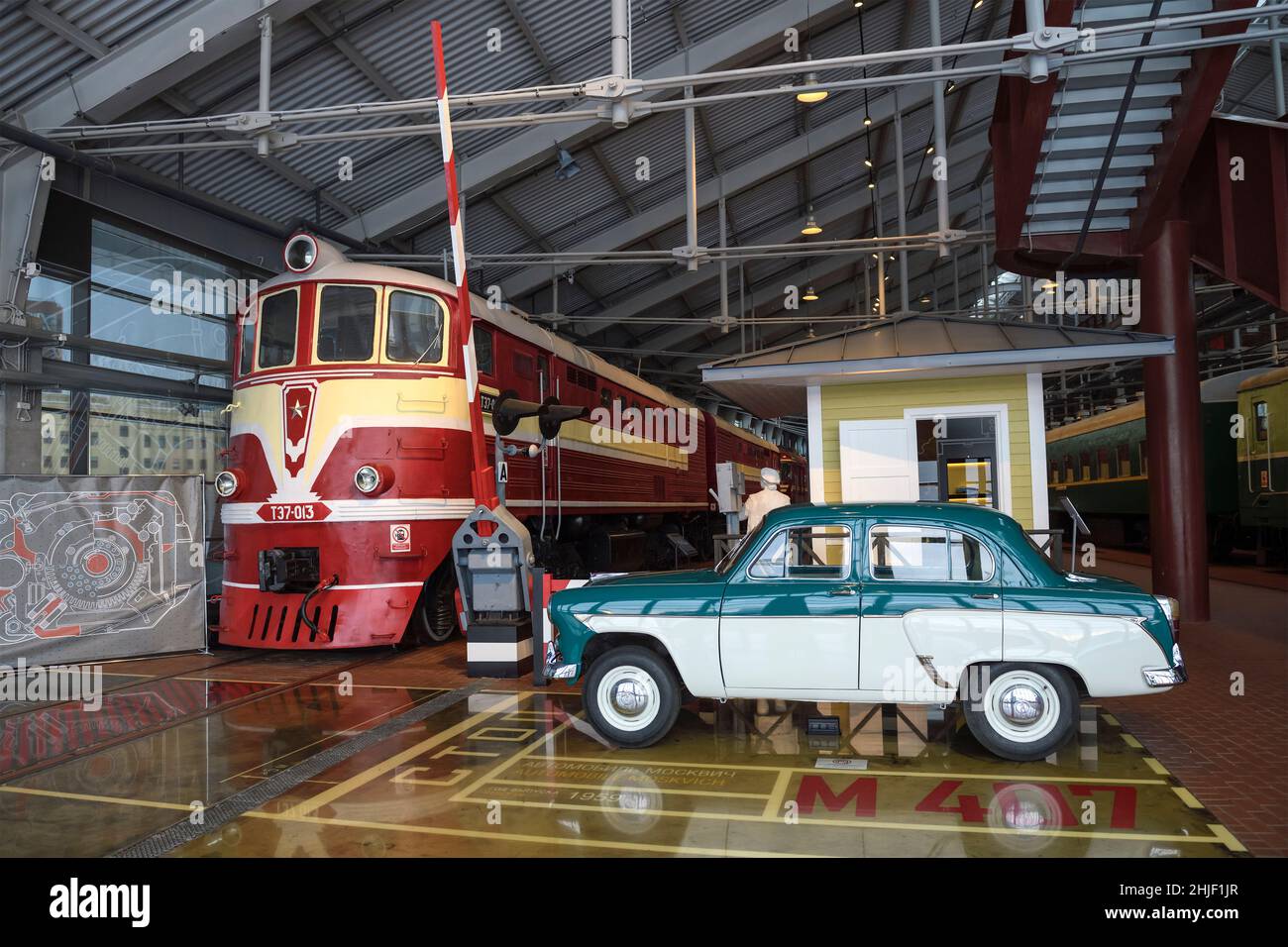 SANKT PETERSBURG, RUSSLAND - 12. JANUAR 2022: Modell eines Bahnübergangs mit einer Diesellokomotive aus dem Jahr TE7 und einem Moskwitsch-407. Museum der Russischen Eisenbahn Stockfoto