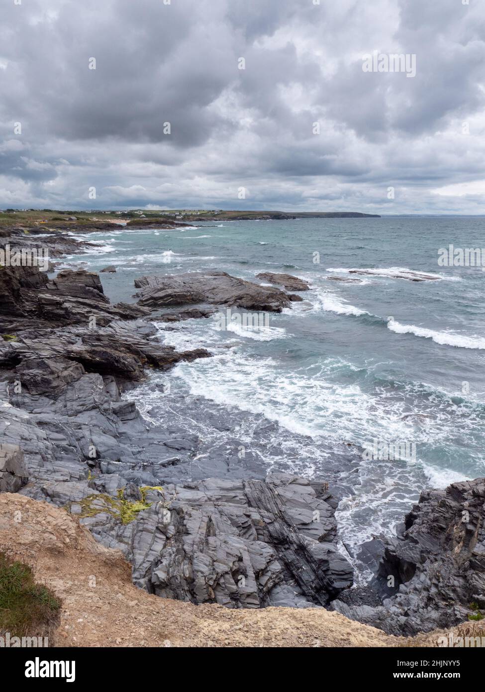 Ein Blick auf den Atlantik an der felsigen Küste von North Cornwall in der Nähe von Treyarnon Bay, der das Meer, die Wellen und einen grauen, klirrenden Himmel im Sommer in Großbritannien zeigt Stockfoto