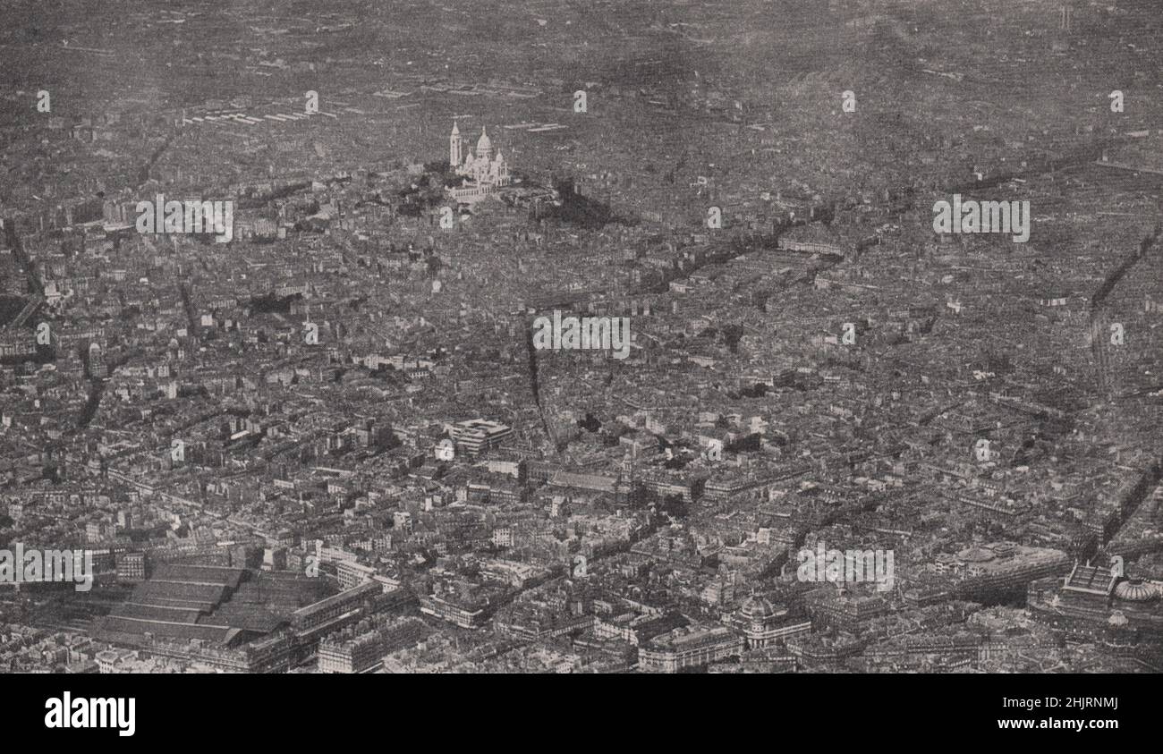 Bevölkerungsreiches Viertel von Montmartre aus der Luft, das die wunderschöne, weiße Steinbasilika zeigt. Paris (1923) Stockfoto