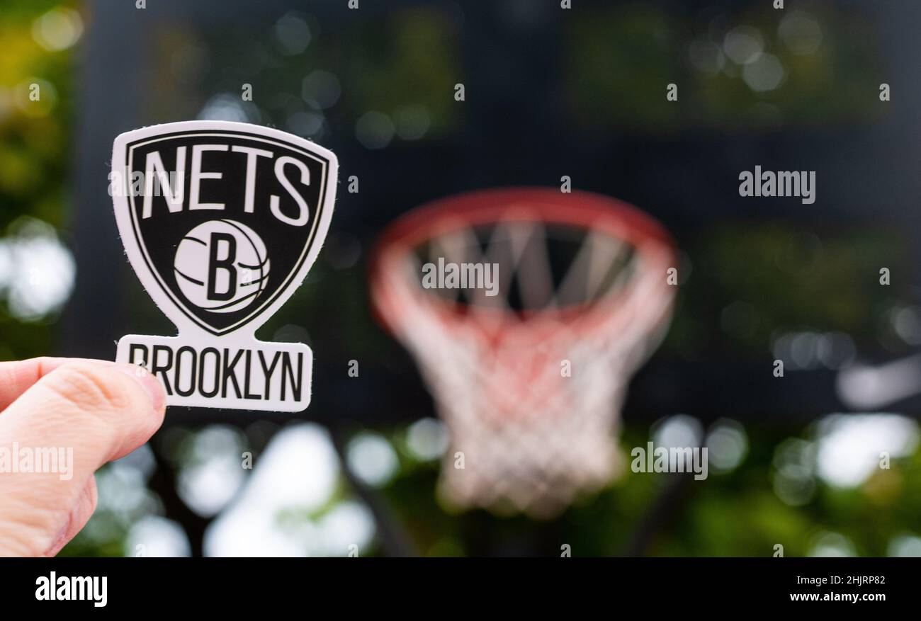 15. September 2021, New York, USA, Ein Mann hält das Logo des Brooklyn Nets Basketballclubs in der Hand auf dem Sportplatz. Stockfoto
