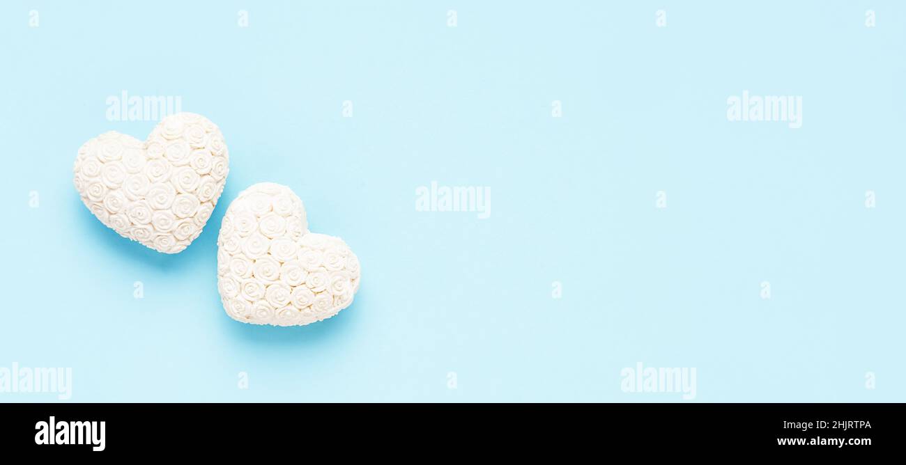 Valentinstag Hintergrund. Zwei weiße Herzen auf hellblauem Hintergrund. Flach liegend, Banner, Kopierraum für Text Stockfoto