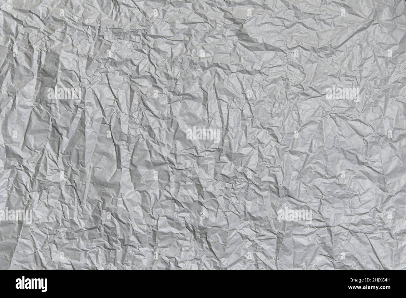 Zerknitterte graue Papierstruktur. Abstrakter leerer grauer Hintergrund für Design Stockfoto