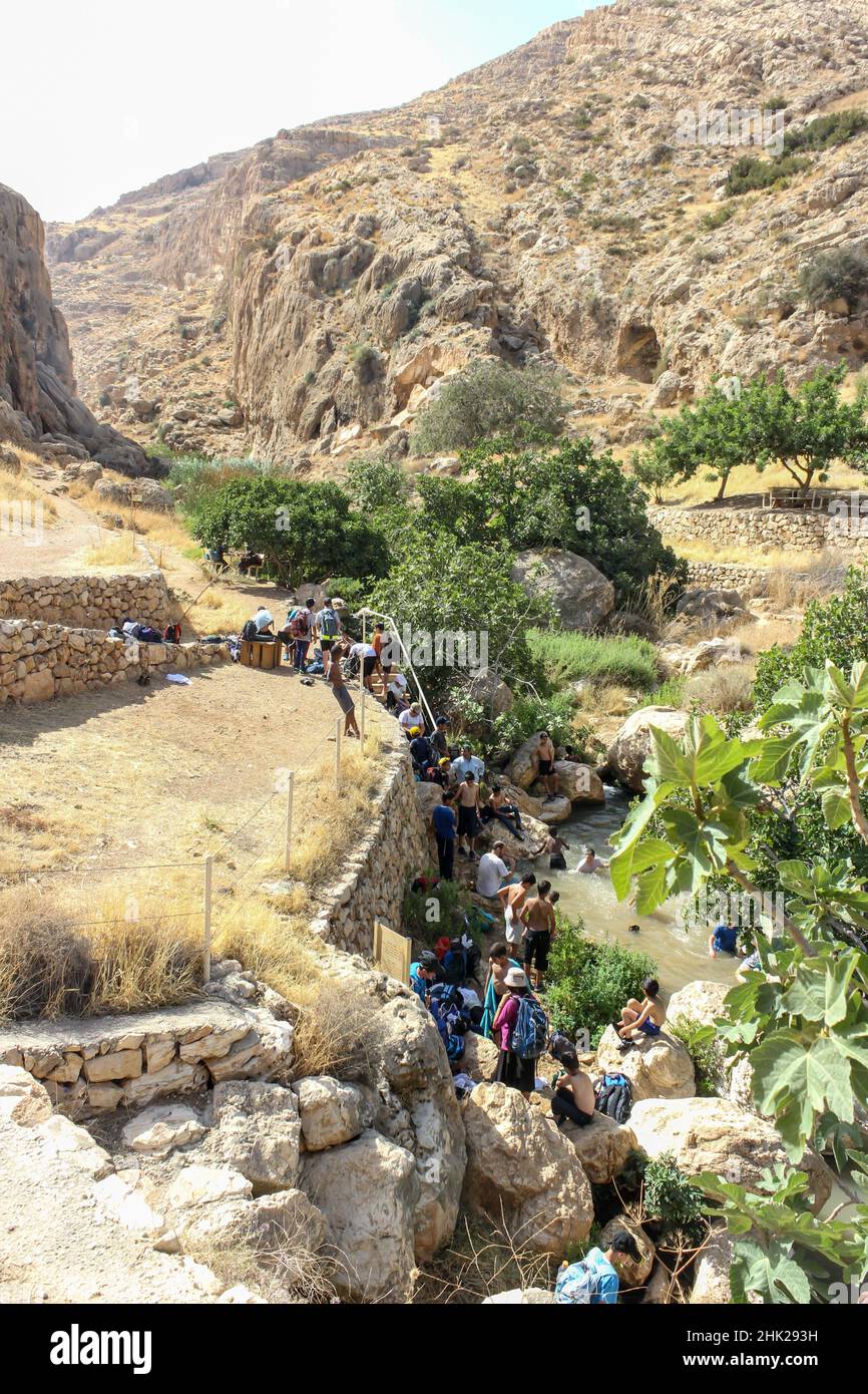 Die Menschen versammeln sich an einer Quelle im Naturschutzgebiet ein Prat entlang des Baches im Wadi Qelt bei Almon, AKA: Anatot, im Westjordanland. Stockfoto