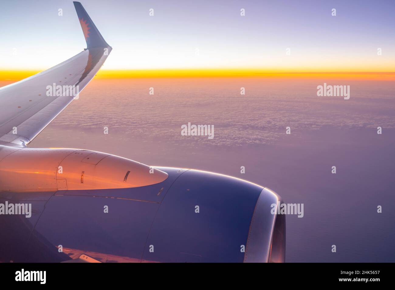 Blick auf Flugzeugmotor und Wolken über dem Meer bei Sonnenuntergang, Atlantik, Europa Stockfoto