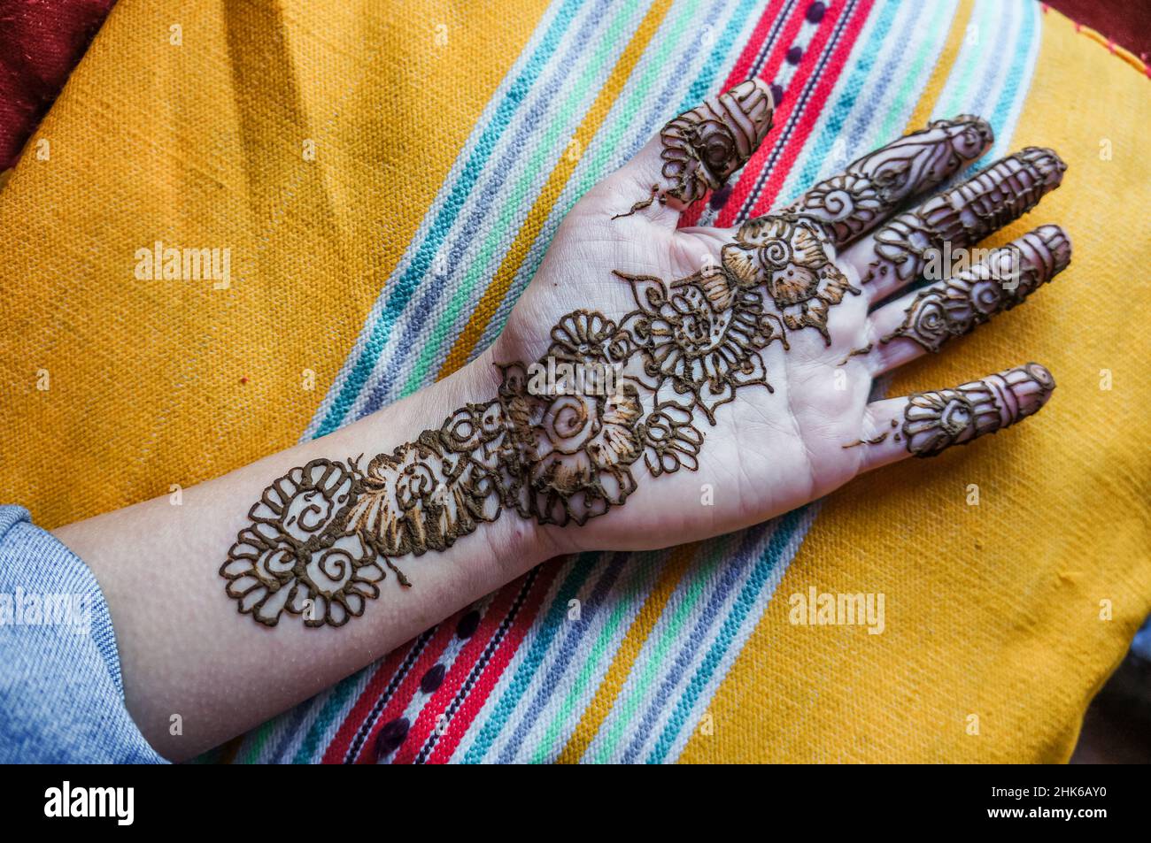 Frauenhand frisch verziert mit Blumenmotiven in Henna-Paste Stockfoto