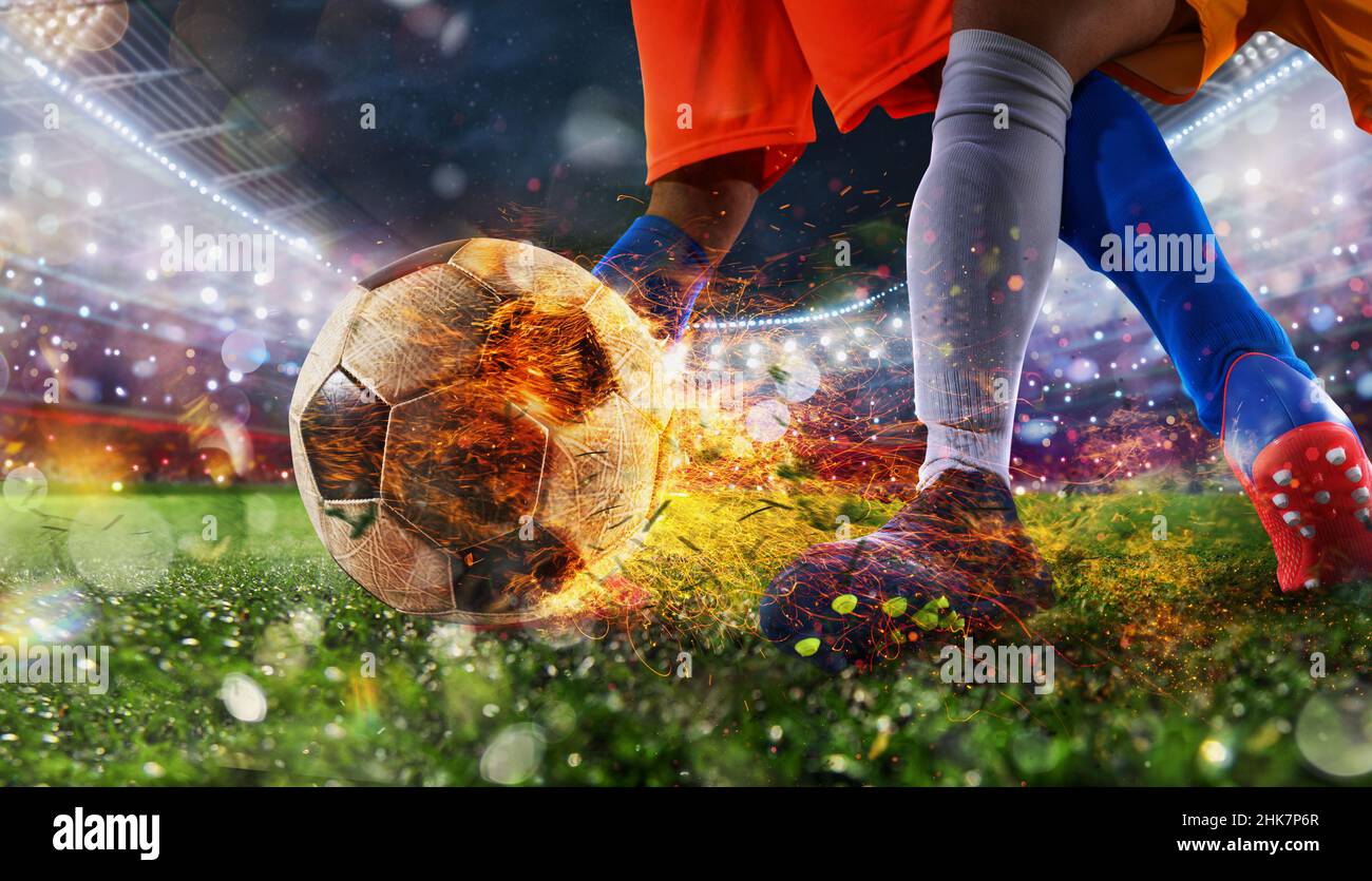 Fußballspieler mit feurigem Soccerball während des Spiels Stockfoto