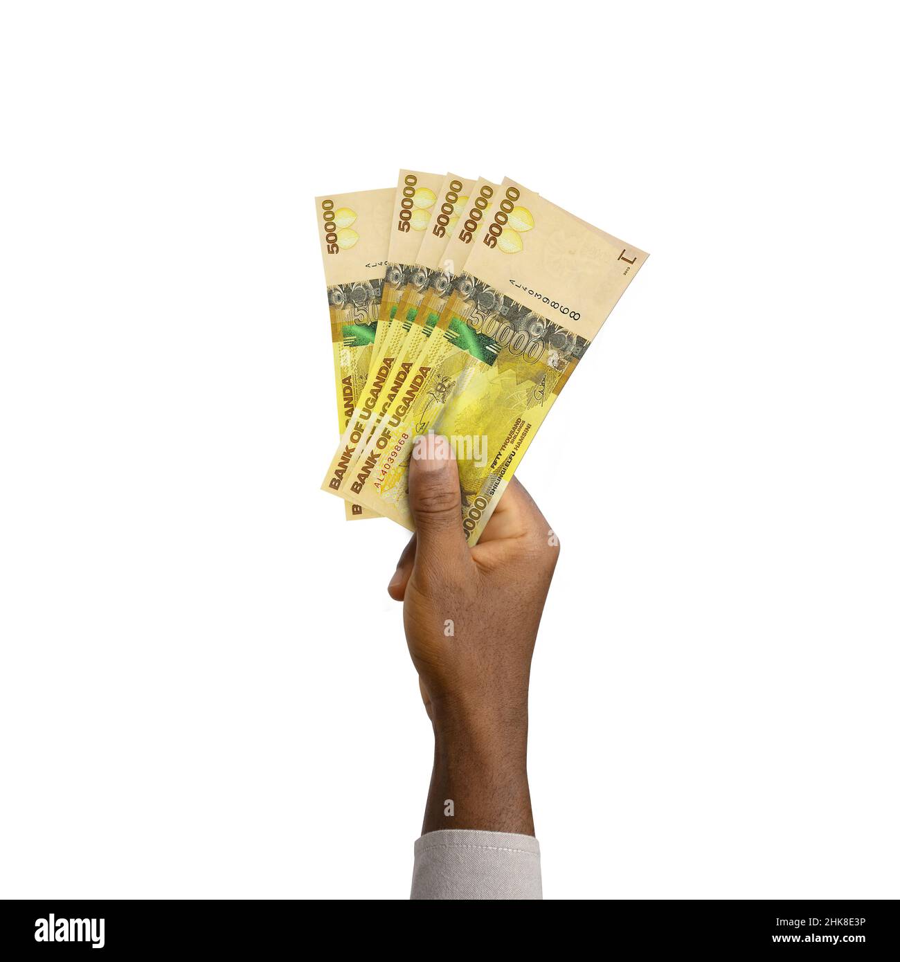 Schwarze Hand mit 3D gerenderten ugandischen Schilling-Noten Stockfoto