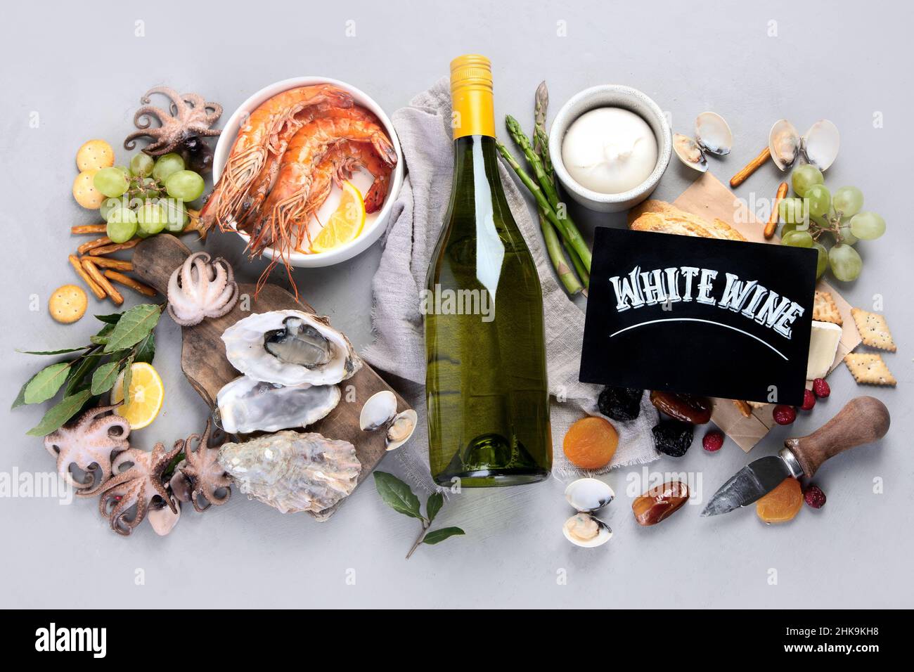 Weißweinflasche auf grauem Hintergrund. Meeresfrüchte und Vorspeisen. Draufsicht, flach liegend Stockfoto