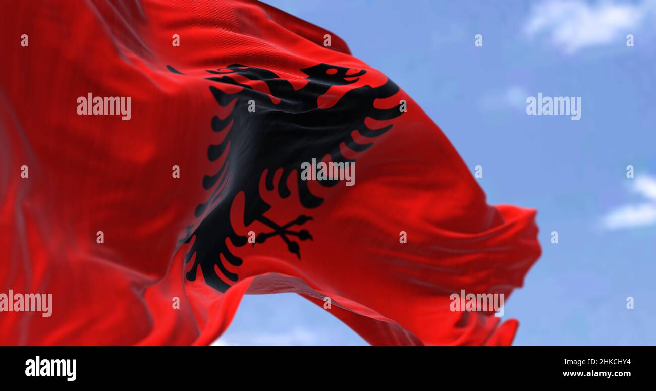 Detail der Nationalflagge Albaniens, die an einem klaren Tag im Wind winkt. Demokratie und Politik. Patriotismus. Europäisches Land. Selektiver Fokus. Süden Stockfoto