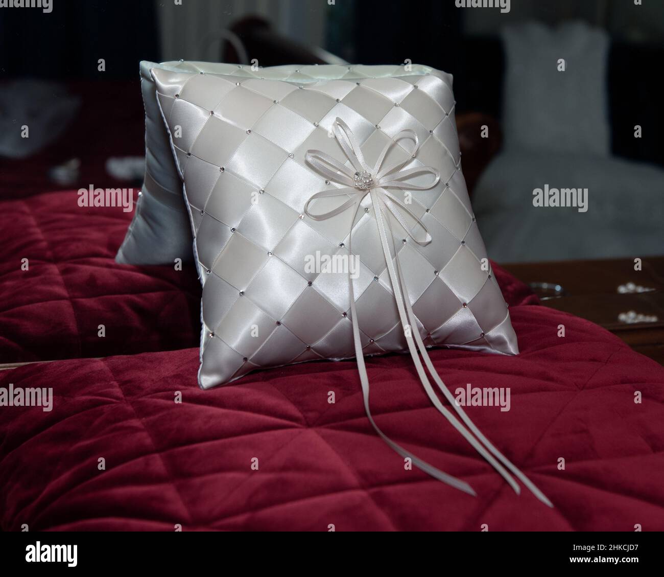 Glänzendes Hochzeitskissen aus Satin, das der Ringträger während der Zeremonie tragen kann. Stockfoto
