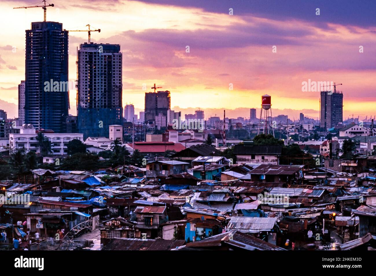 Kontrast zwischen Hochhäusern in Makati und Shanty-Häusern in Guadalupe, im Zentrum von Manila, Philippinen bei Sonnenuntergang Stockfoto