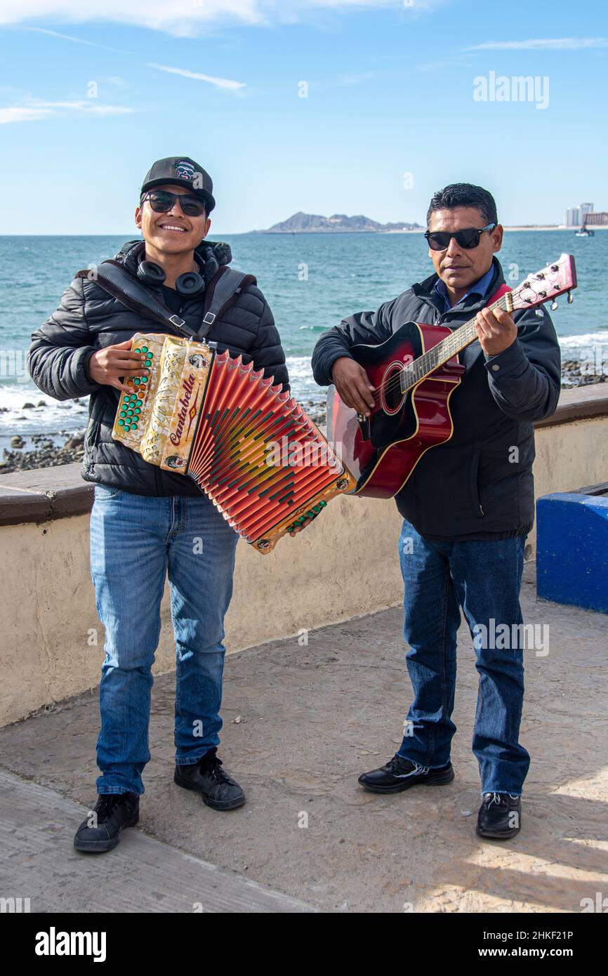 Zwei Musiker schlendern entlang der Malecon in der Hafenstadt Puerto Penasco, Baja California, Mexiko Stockfoto