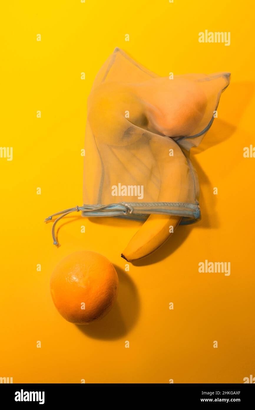 Früchte in einem Einwegbeutel auf gelbem Hintergrund. Stockfoto