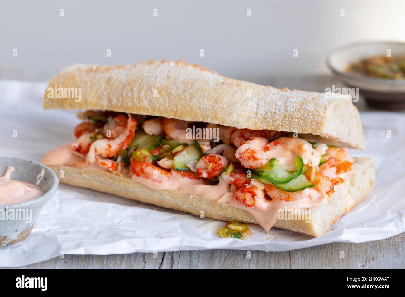 Steingebackene Baquette mit Krebsen, eingelegten Gurken, würzigem Dressing und sriracha-Mayonnaise Stockfoto