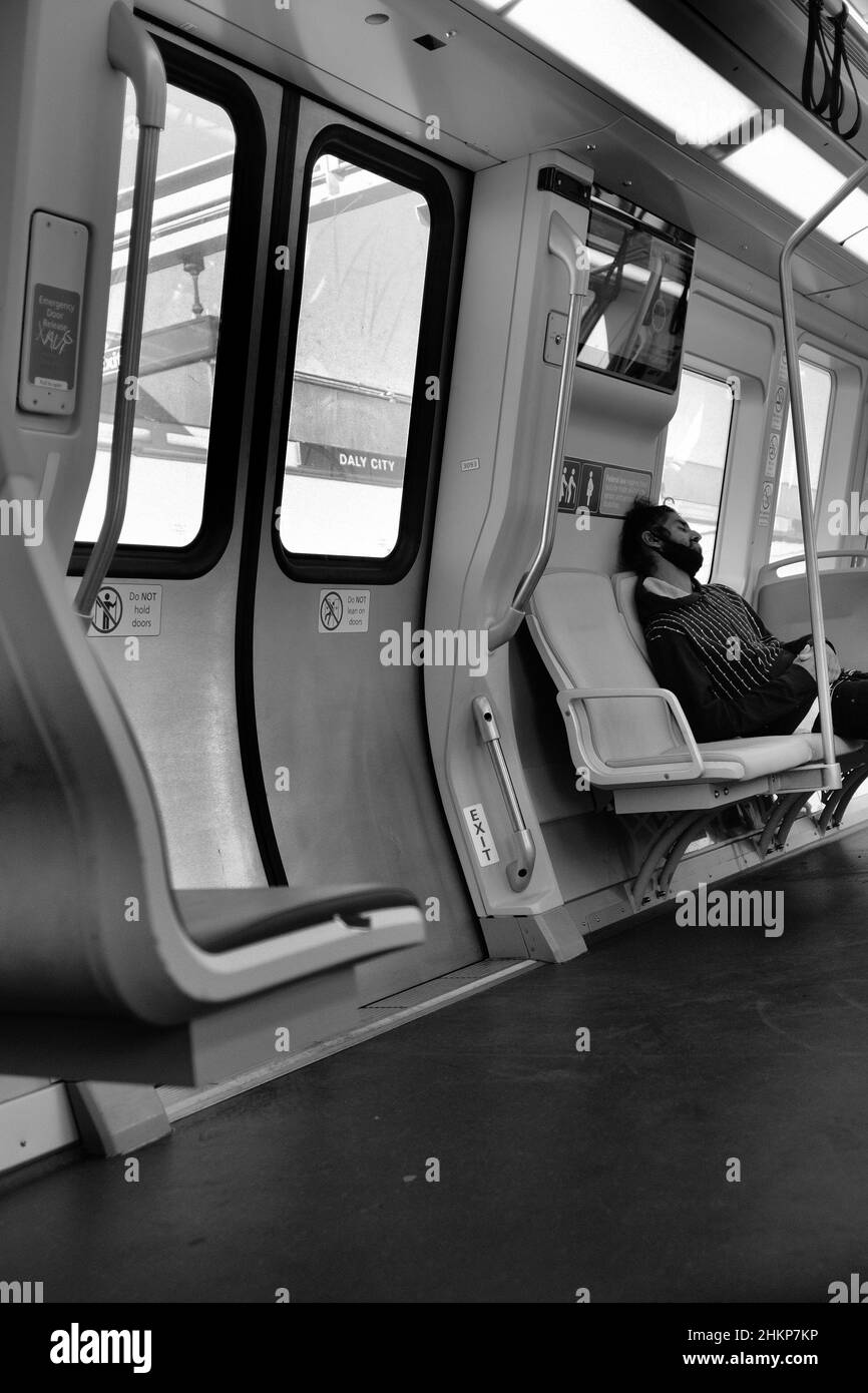 Schwarzweiß-Schwarzweißbild eines Pendlers in einem San Francisco Bay Area Rapid Transit-Zug; BART; San Francisco, Kalifornien, öffentlicher Nahverkehr. Stockfoto
