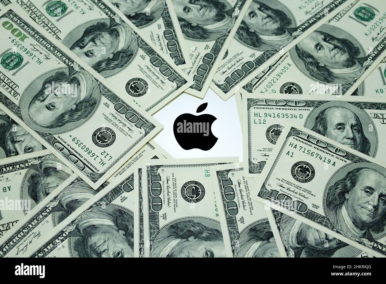 Apple-Firmenlogo auf dem Laptop Macbook M1, umgeben von US-Dollar-Banknoten. Konzept. Selektiver Fokus. Großbritannien, Stafford, 18. Dezember 2021. Stockfoto