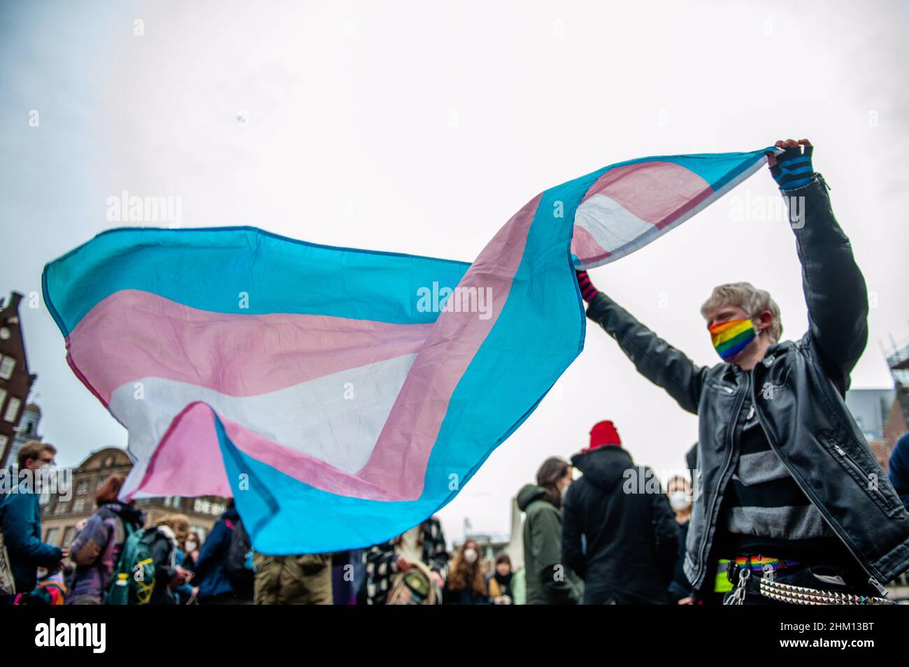 Während der Demonstration wird ein Protestler mit einer Transgender-Flagge gesehen.die Organisation 'Trans Zorg Nu' (auf Englisch 'Trans Care Now') organisierte in Amsterdam eine Demonstration gegen den schlechten Zustand der Transgender-Gesundheitsversorgung, die langen Wartelisten, Und ein strukturell anderes Übergangssystem zu fordern, das auf Selbstbestimmung und Dezentralisierung basiert. Rund tausend Menschen versammelten sich auf dem Dam-Platz, um ihre Unterstützung für Trans-Menschen und auch gegen die Amsterdamer UMC (ehemals Vumc) zu zeigen, die das akademische medizinische Zentrum und das größte Pflegezentrum für Menschen mit Geschlechtsdysph ist Stockfoto