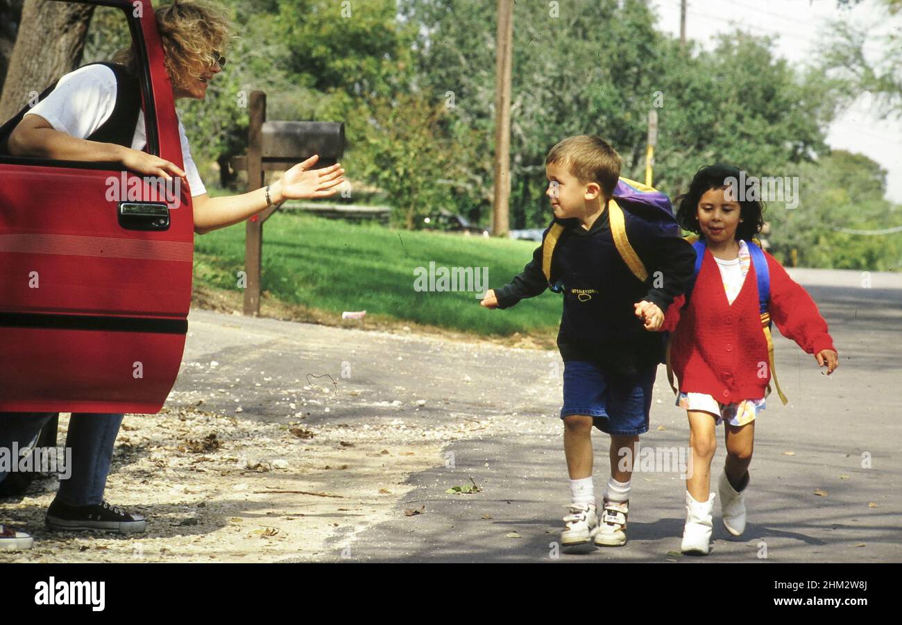 Austin Texas USA, 1993: Mädchen und Jungen der Grundschule laufen vor Fremden weg und versuchen, sie in ein Fahrzeug zu locken, während sie von der Schule nach Hause gehen. ©Bob Daemmrich Stockfoto