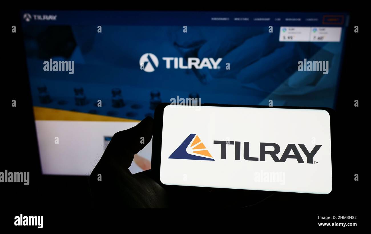 Person, die ein Smartphone mit dem Logo des kanadischen Cannabisunternehmens Tilray Inc. Auf dem Bildschirm vor der Website hält. Konzentrieren Sie sich auf die Telefonanzeige. Stockfoto