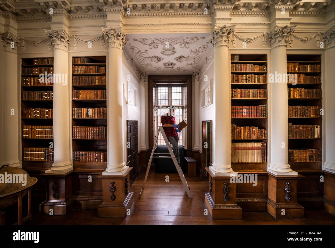 Josh Turner im Temple Newsam House, einem Tudor-jakobeanischen Haus in Leeds, als Mitarbeiter in der georgischen Bibliothek akribische Restaurierungsarbeiten durchführen. Bilddatum: Montag, 7. Februar 2022. Stockfoto Josh Turner im Temple Newsam House, einem Tudor-jakobeanischen Haus in Leeds, als Mitarbeiter in der georgischen Bibliothek akribische Restaurierungsarbeiten durchführen. Bilddatum: Montag, 7. Februar 2022. Stockfoto