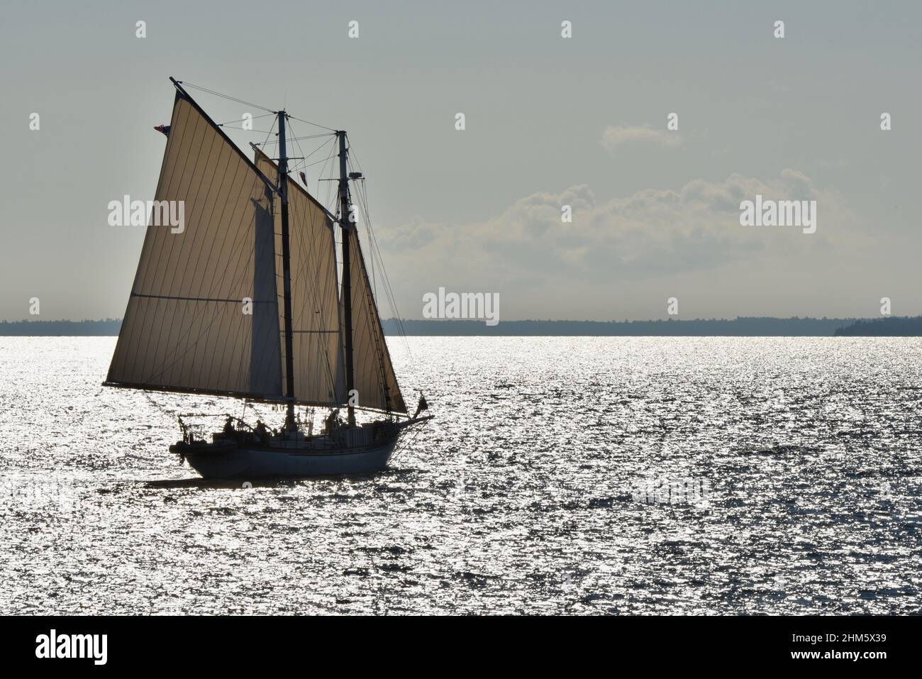 Segelboot-Yacht, die am frühen Morgen des Sommers von Mackinac Island, Michigan, USA, aus dem Hafen abfährt Stockfoto