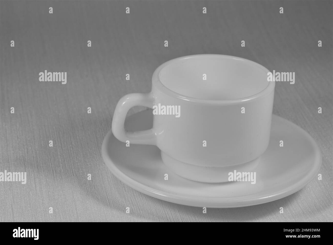 Leere weiße Porzellankaffeetasse auf hellem Hintergrund. Stockfoto