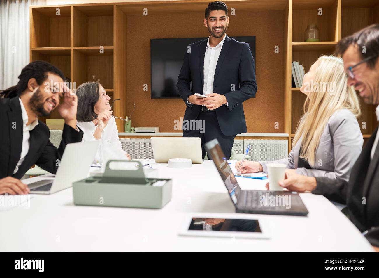 Junger Geschäftsmann als Berater oder Manager zusammen mit dem Business-Team in einem Coaching-Meeting Stockfoto
