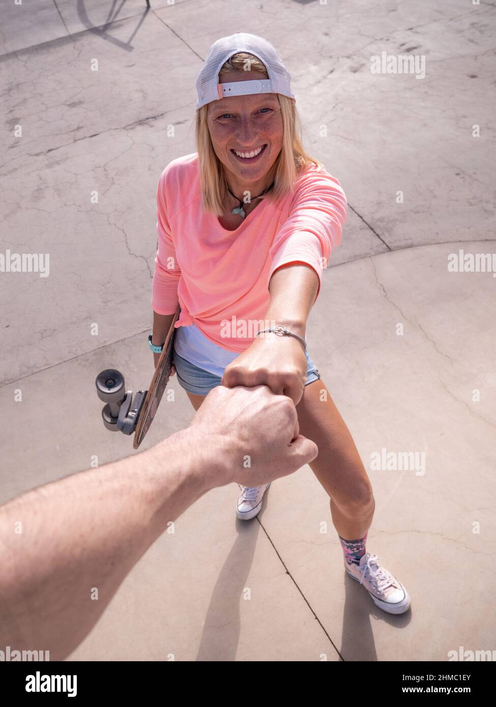 Kaukasische Skaterin Frau tun Faust Pfund Stockfoto