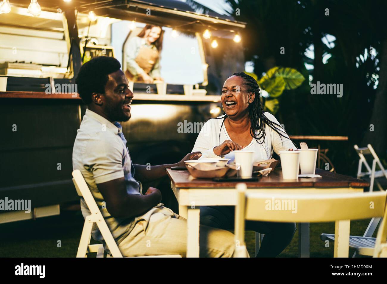 Afrikanische Mutter und Sohn essen Lebensmittel LKW Essen im Freien - Fokus auf Frau Gesicht Stockfoto