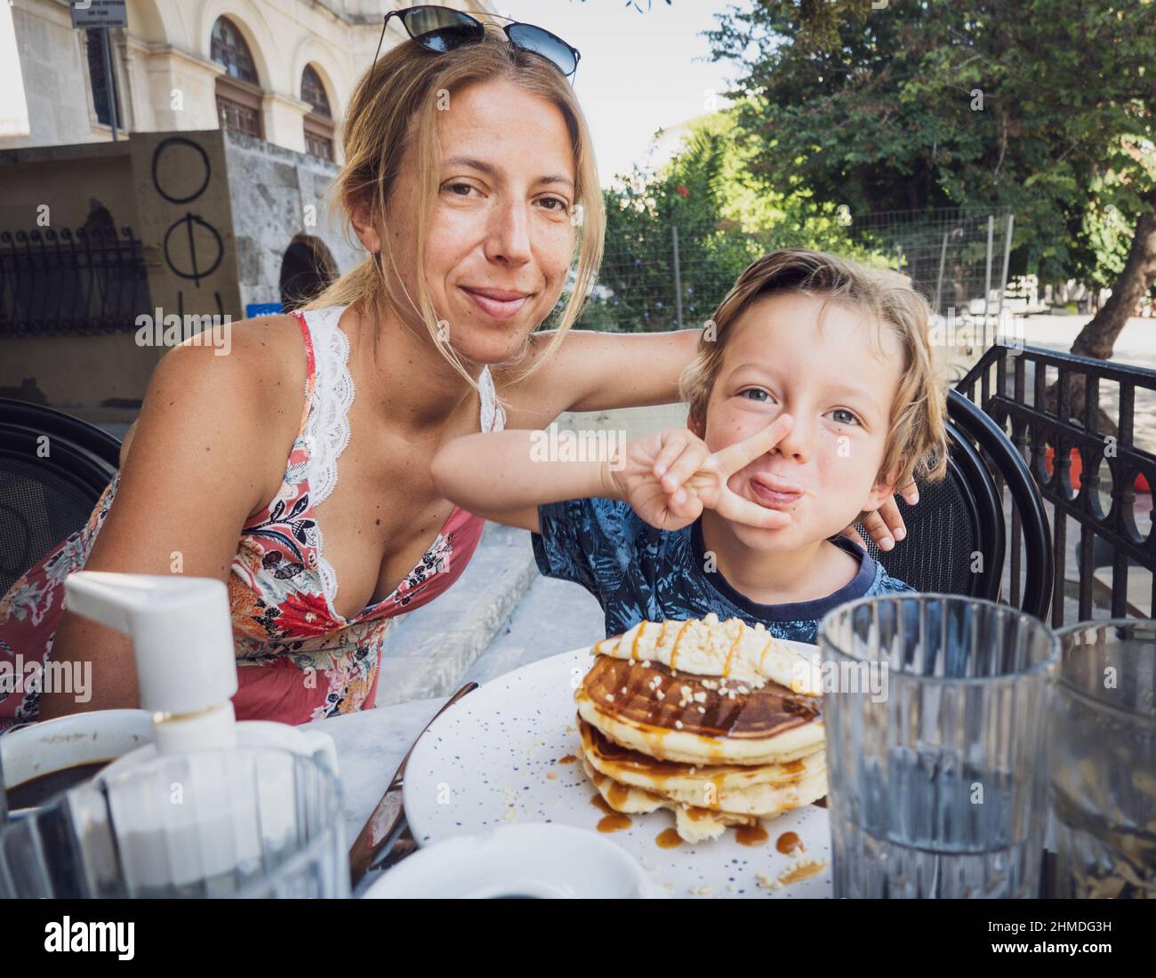 Porträt von Mutter und Sohn, die im Café im Freien sitzen Stockfoto
