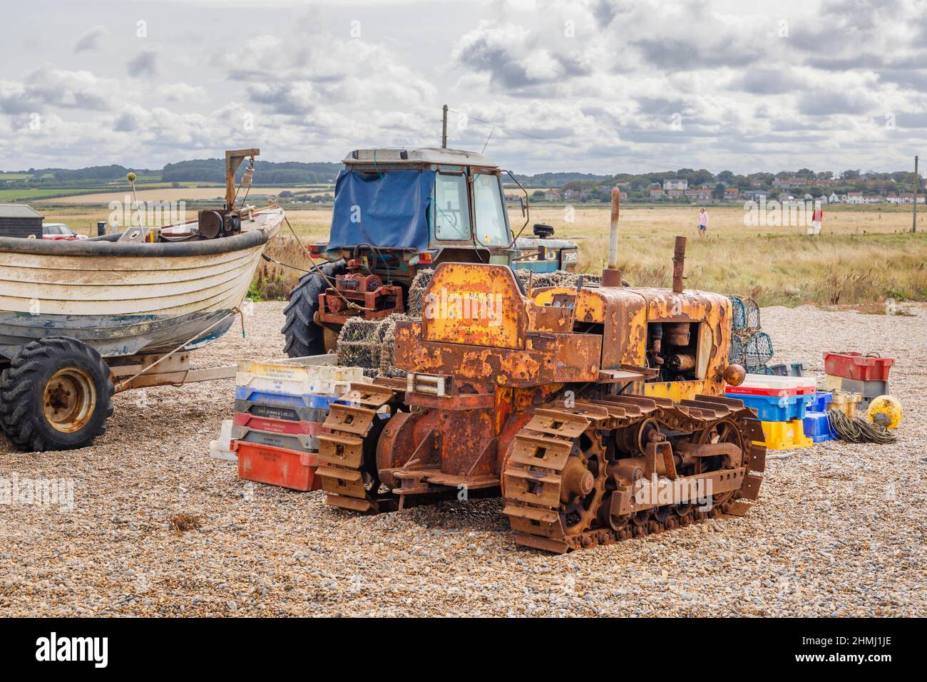 Ein rostiger Vintage-Planierraupen und ein Traktor an einem Kiesstrand, Cley-Next-the-Sea, einem Küstendorf, Nordküste Norfolk, East Anglia, England Stockfoto