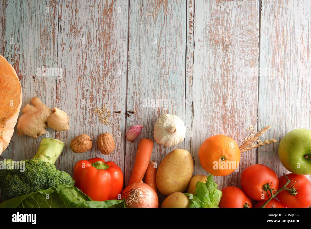 Rahmenhintergrund mit Obst und Gemüse auf unlackiertem blauen Holztisch. Draufsicht. Horizontale Zusammensetzung. Stockfoto