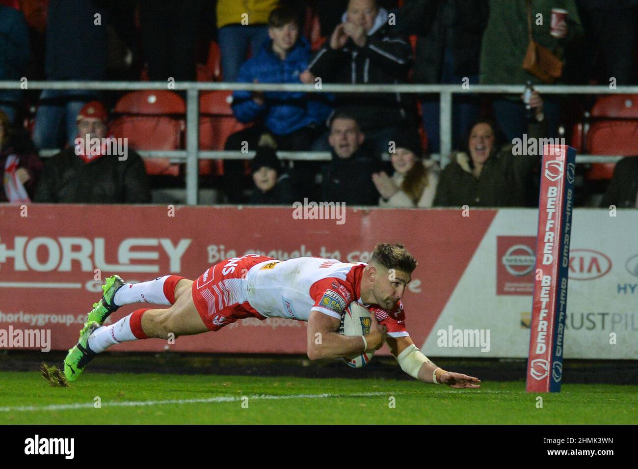 St. Helens, England - 10. Februar 2022 - Thomas Makinson von St. Helens hat während der Rugby League Betfred Super League Runde 1 St. Helens gegen Catalan Dragons im Totally Wicked Stadium, St. Helens, UK Dean Williams, einen Versuch gemacht Stockfoto