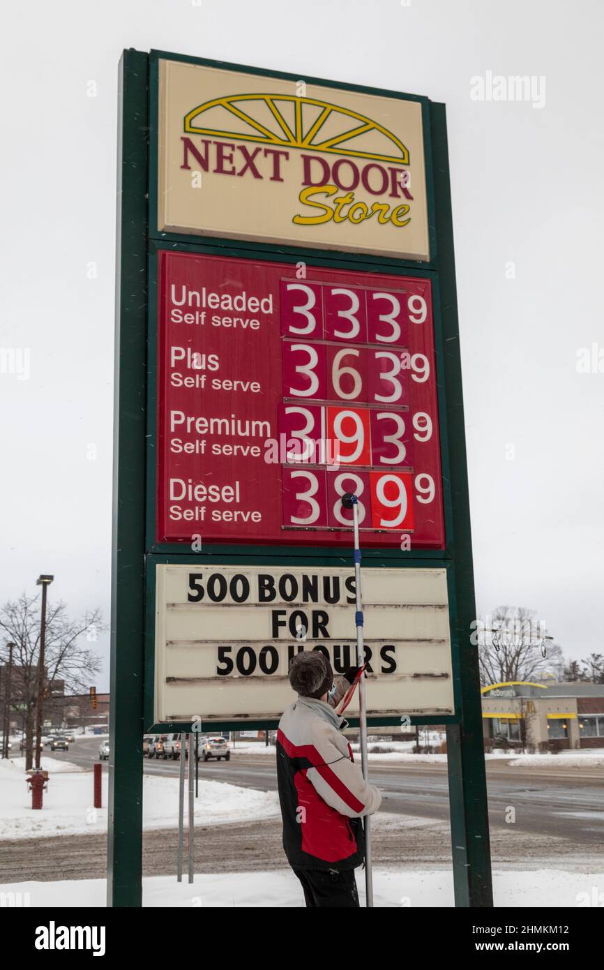 Petoskey, Michigan, USA. 10th. Februar 2022. Ein Arbeiter ändert die Gaspreise in einer Tankstelle/einem Lebensmittelgeschäft des nächsten Door Stores. Kredit: Jim West/Alamy Live Nachrichten Stockfoto