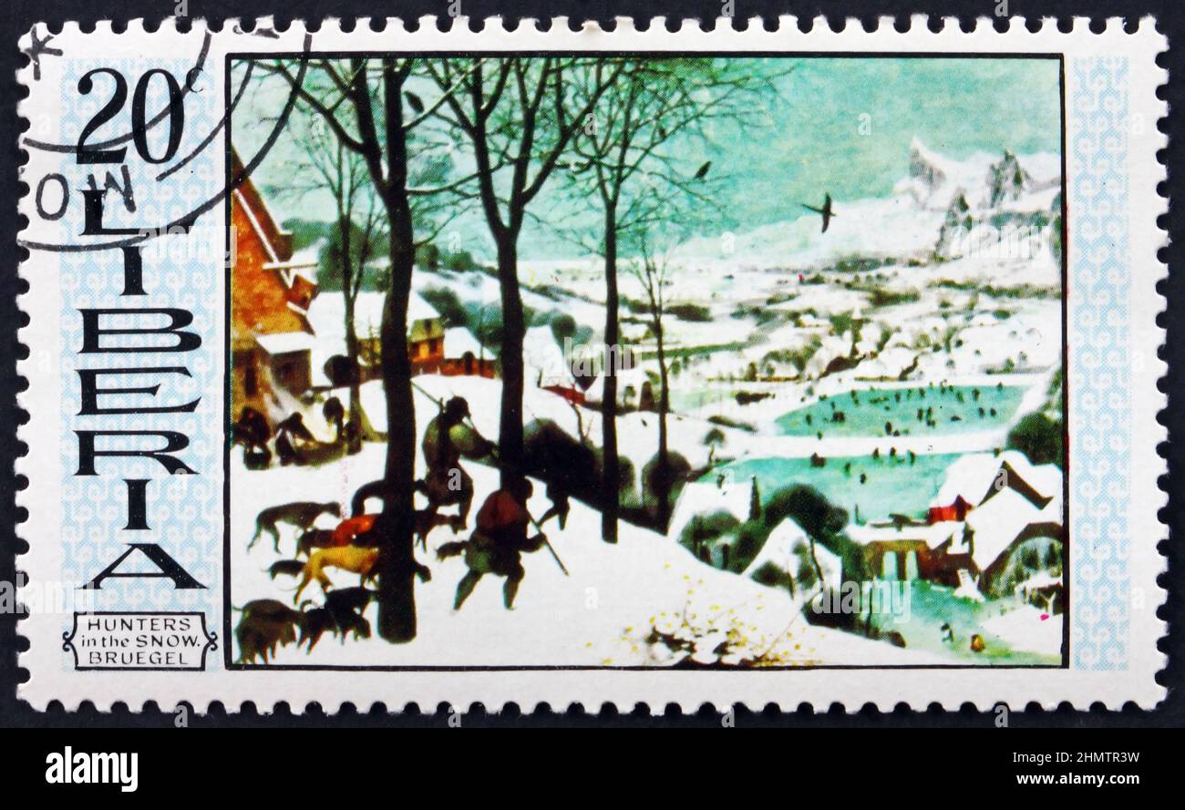 LIBERIA - UM 1969: Eine in Liberia gedruckte Marke zeigt Jäger im Schnee, Gemälde von Pieter Bruegel dem Älteren, niederländischer Maler, um 1969 Stockfoto