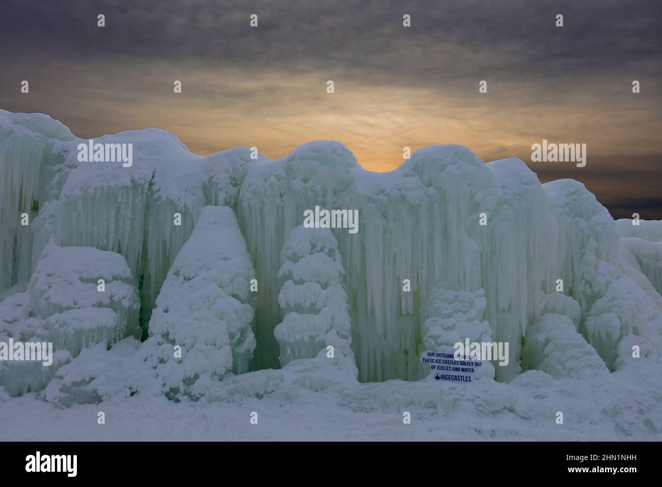 Eine Wand aus gefrorenem Wasser und Eiszapfen gegen den Sonnenuntergang an den Eisschlössern im Genfersee, Wisconsin, USA Stockfoto